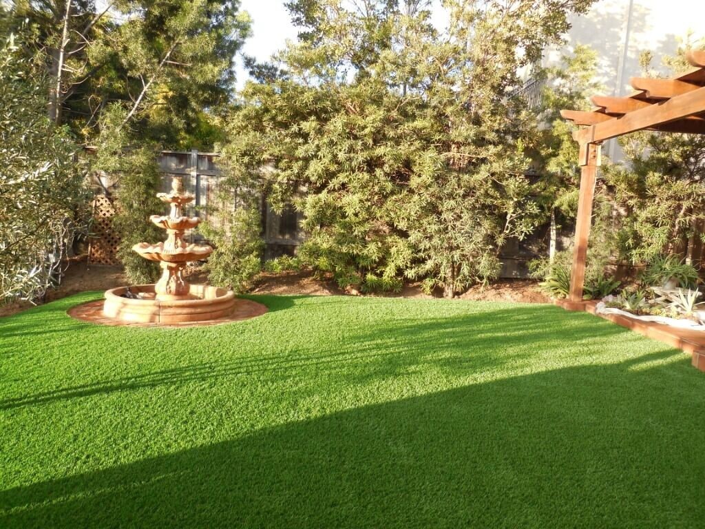 Artificial grass backyard with fountain