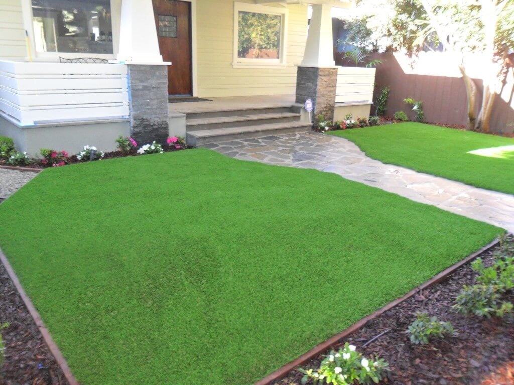 Artificial grass front yard with stone walkway