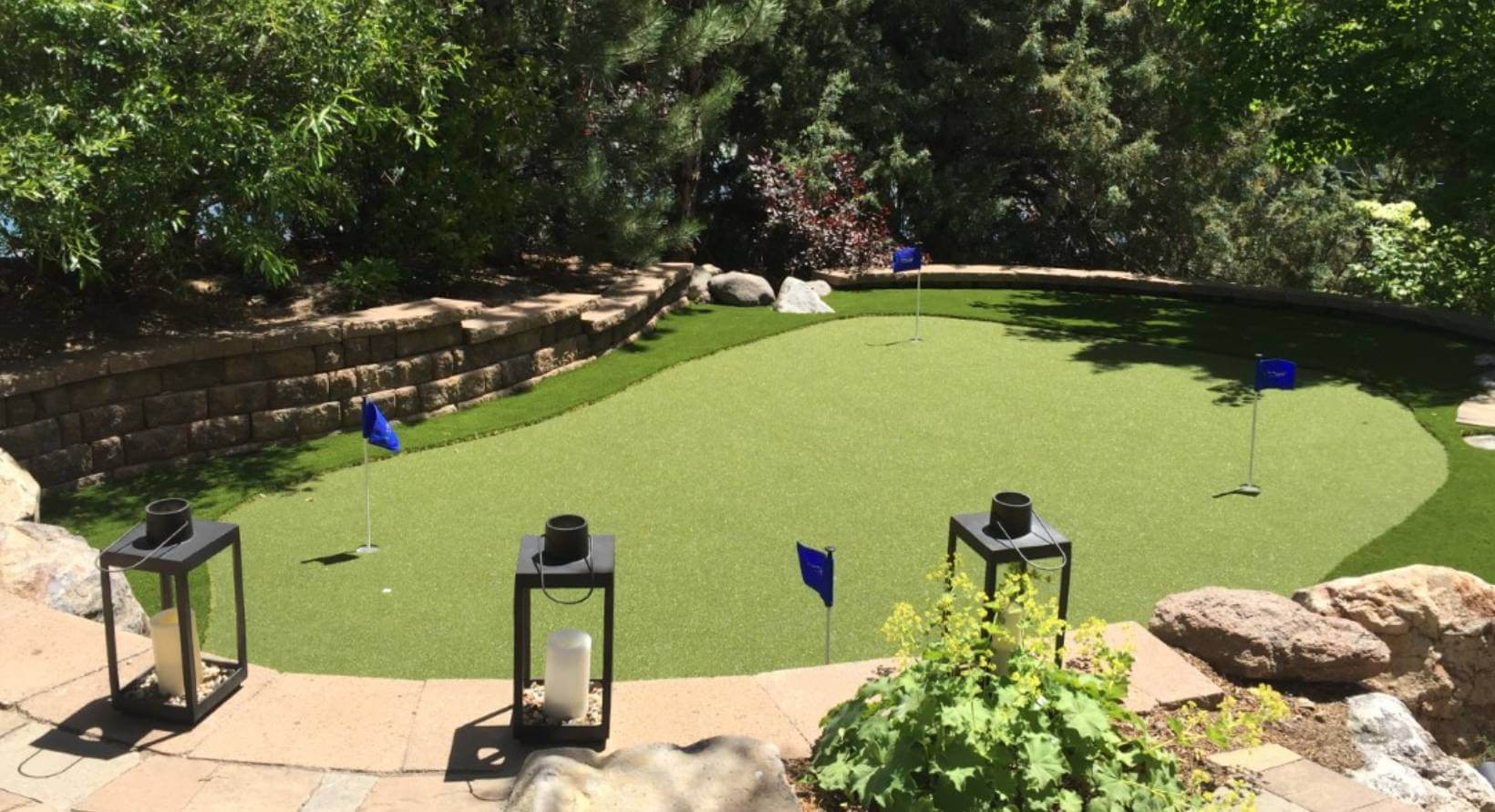 Backyard putting green with blue flags from Nevada Artificial Grass