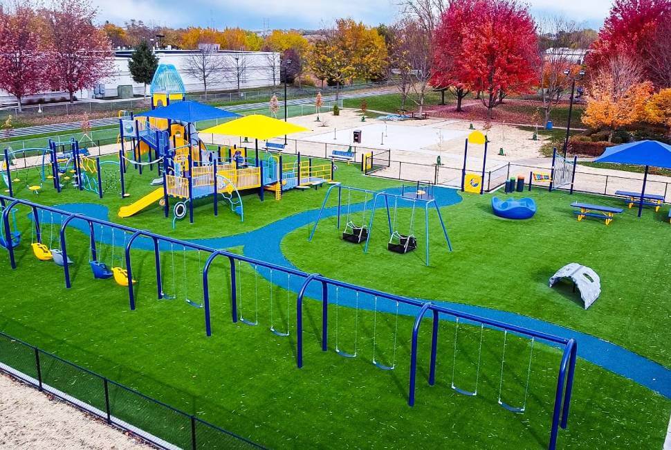 Blue and Yellow playground equipment installed on Artificial Grass