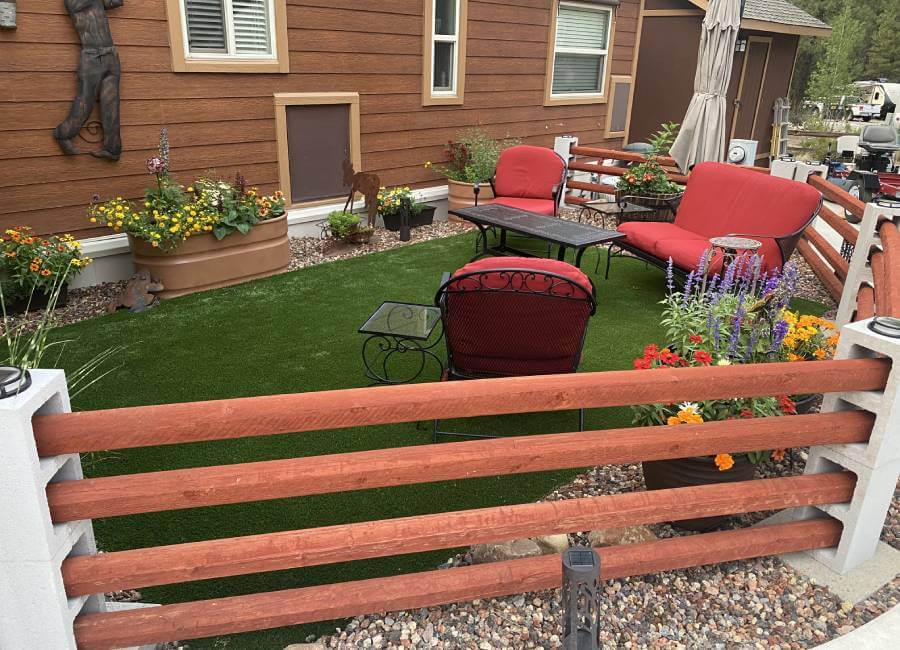 Nevada residential artificial grass backyard with red furniture