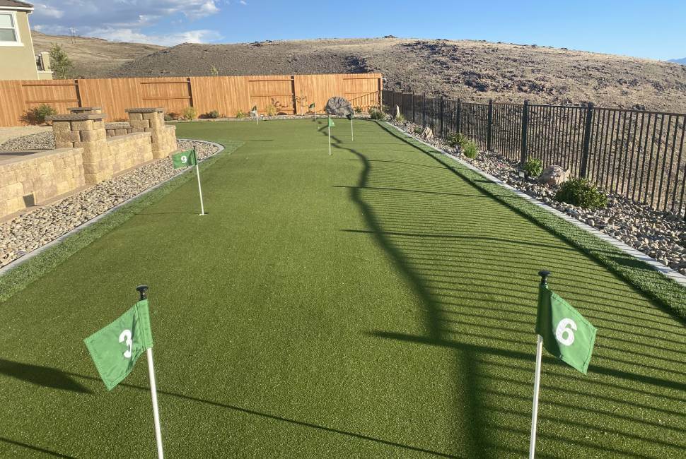 Backyard putting green with a desert landscape background