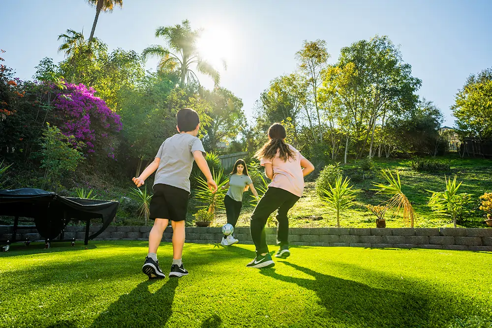 kids playing soccer artificial grass lawn 